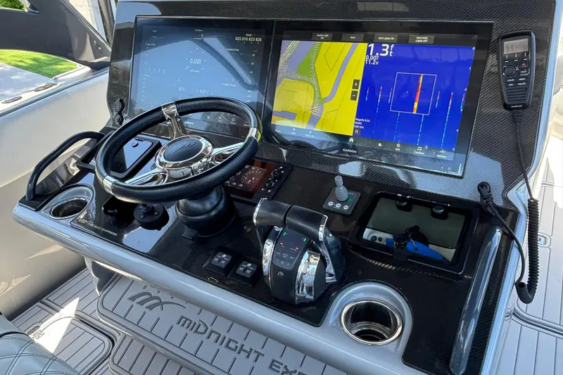 Slide: The Image of 2021 Midnight Express 37 Open boat dashboard with advanced navigation displays and controls. - 7