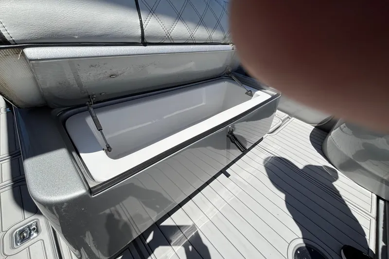 Slide: The Image of Open storage compartment on a 2021 Midnight Express 37 Open boat, featuring sleek design. - 8