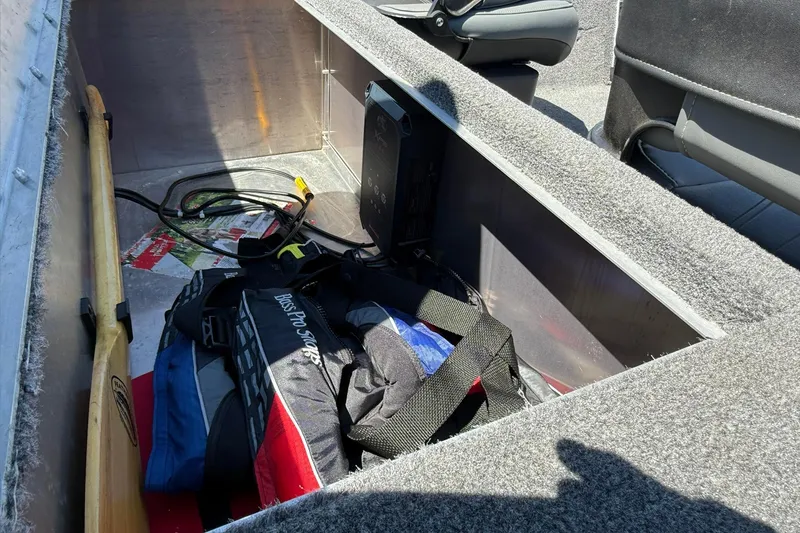Slide: The Image of 2020 Tracker Bass Tracker Classic XL storage compartment with life jackets and equipment. - 11