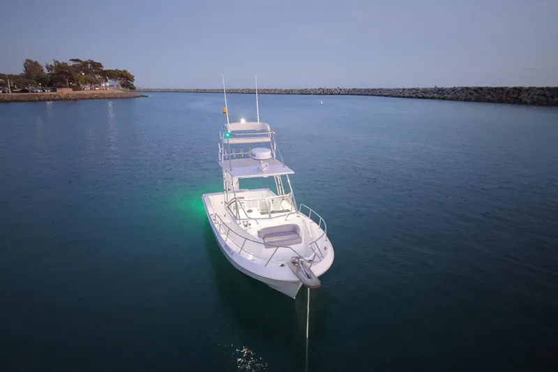 Slide: The Image of 1985 Chris-Craft 21 Scorpion Cuddy boat anchored in calm waters at dusk. - 13