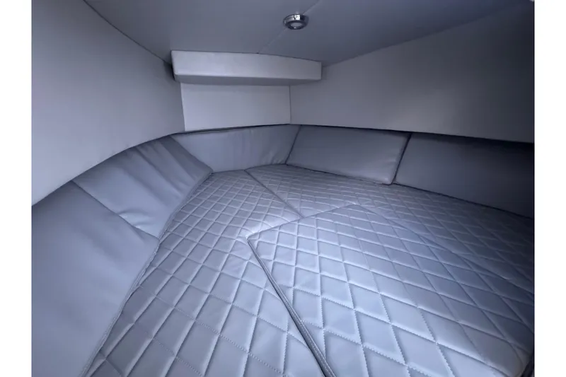 Slide: The Image of 1985 Chris-Craft 21 Scorpion Cuddy cabin interior with quilted cushions and sleek design. - 29