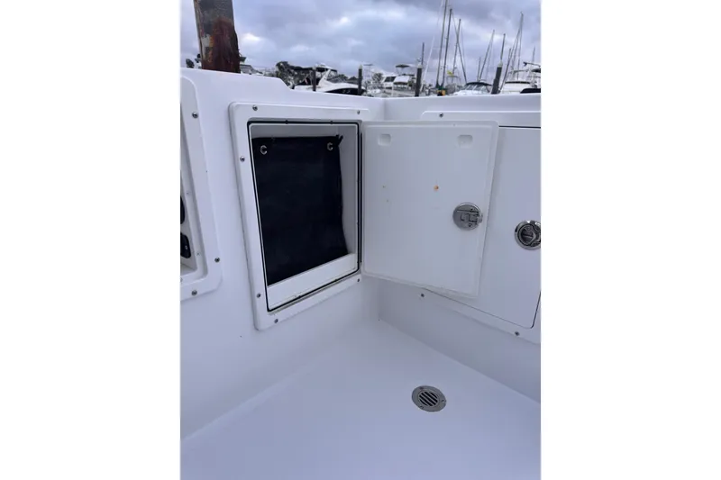 Slide: The Image of 1985 Chris-Craft 21 Scorpion Cuddy boat interior storage compartment with open hatch. - 31