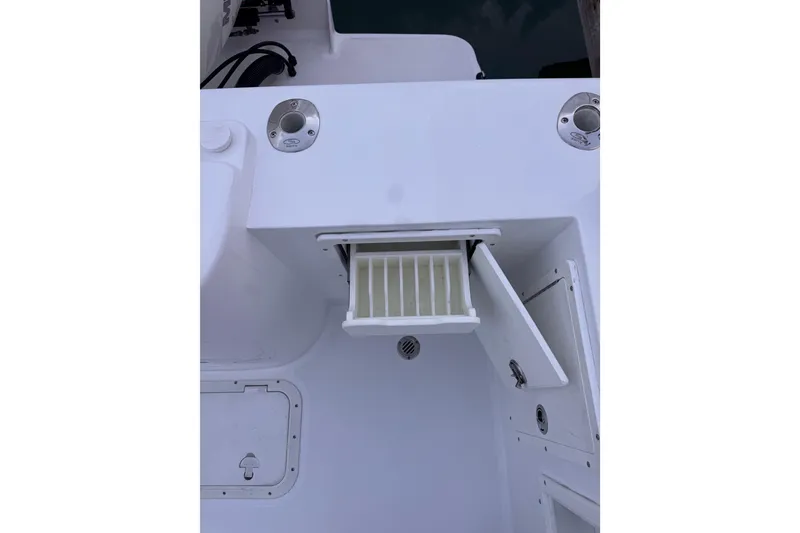 Slide: The Image of 1985 Chris-Craft 21 Scorpion Cuddy boat interior with open storage compartment. - 33
