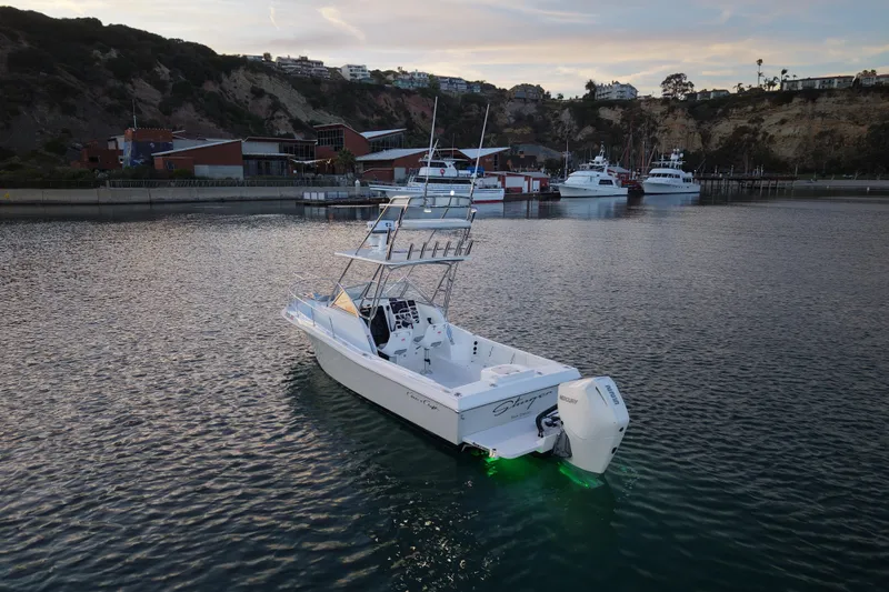Slide: The Image of 1985 Chris-Craft 21 Scorpion Cuddy boat docked in scenic harbor at sunset. - 6