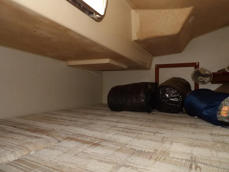 Slide: The Image of Interior cabin of 1990 Island Packet 32 sailboat with sleeping bags and fan. - 24