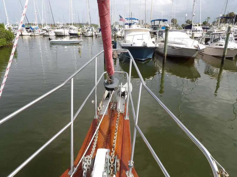 Slide: The Image of Bow view of 1990 Island Packet 32 sailboat docked in a marina. - 31