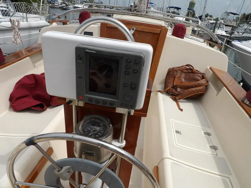 Slide: The Image of Cockpit of 1990 Island Packet 32 sailboat with navigation equipment and leather bag. - 9