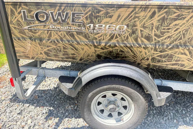 Slide: The Image of 2022 Lowe Roughneck 1860CC boat on trailer with camouflage design. - 12