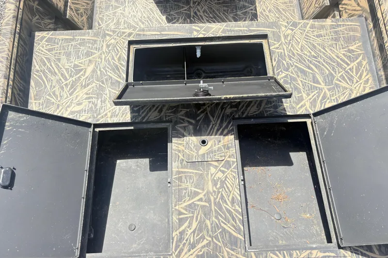 Slide: The Image of Open storage compartments on a 2022 Lowe Roughneck 1860CC boat deck. - 9