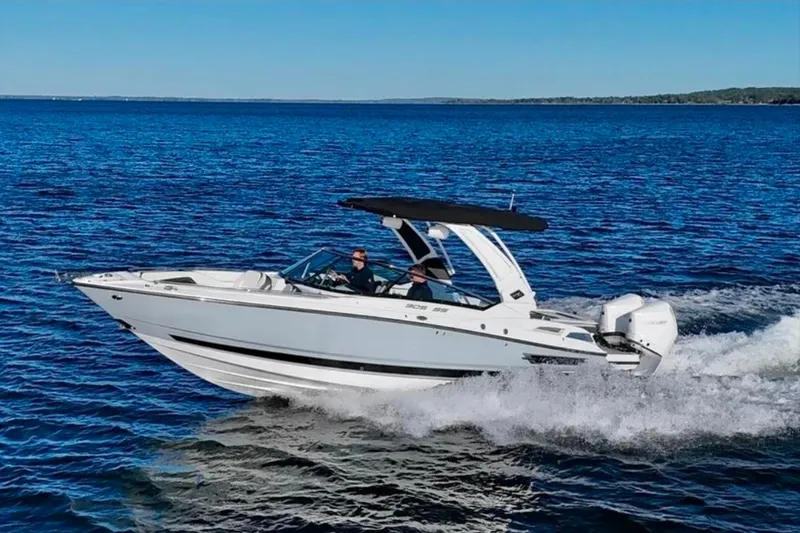 The Image of 2022 Monterey 305SS Super Sport boat cruising on open water under clear blue skies. - 0