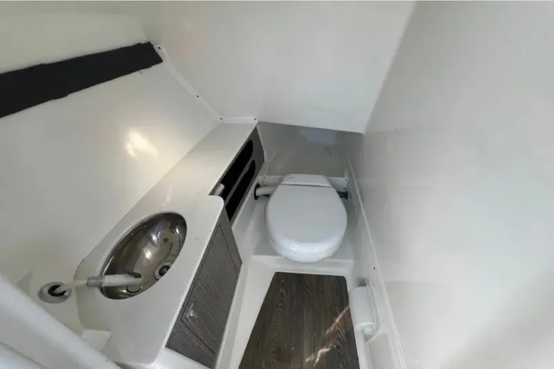 Slide: The Image of 2022 Monterey 305SS Super Sport boat bathroom with sink and toilet. - 10