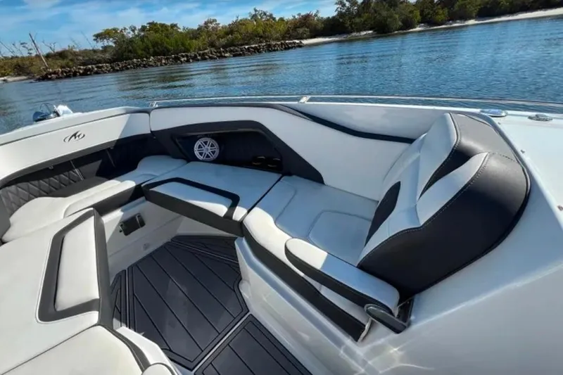Slide: The Image of 2022 Monterey 305SS Super Sport boat interior with luxurious seating and scenic water view. - 11