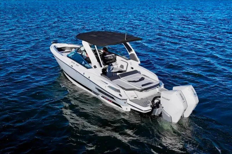 Slide: The Image of 2022 Monterey 305SS Super Sport boat cruising on open water. - 2