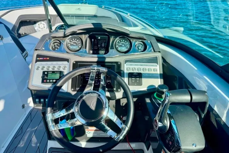 Slide: The Image of Cockpit of 2022 Monterey 305SS Super Sport boat with modern controls and steering wheel. - 7