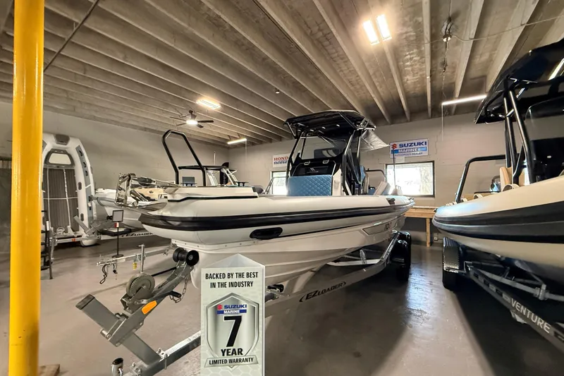 The Image of 2026 Highfield ADV7 boat in showroom with Suzuki Marine warranty sign. - 1