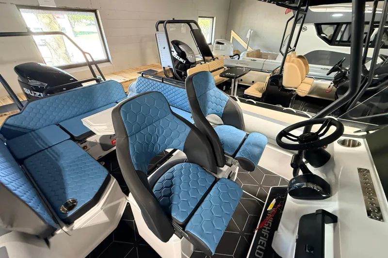 Slide: The Image of 2026 Highfield ADV7 boat interior with blue seating and modern steering console. - 10