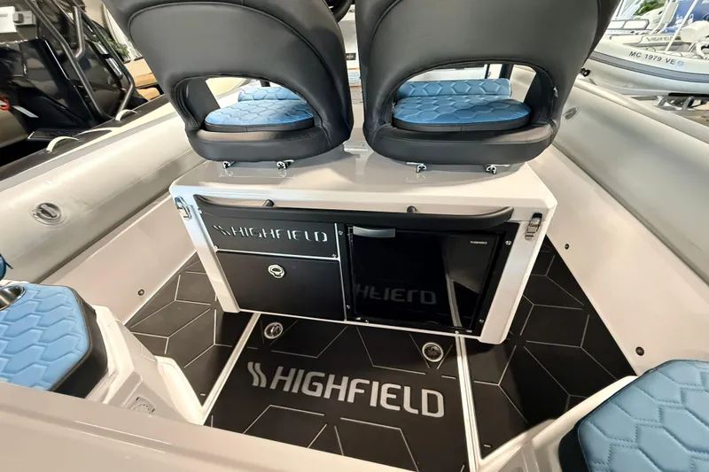 Slide: The Image of Interior of 2026 Highfield ADV7 boat with blue seating and branded flooring. - 11