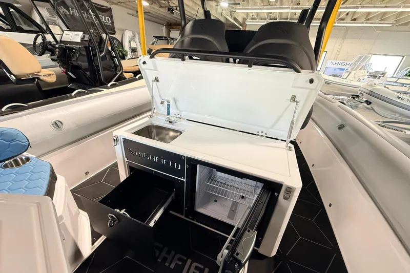 Slide: The Image of 2026 Highfield ADV7 boat interior with open storage compartments and sink. - 12