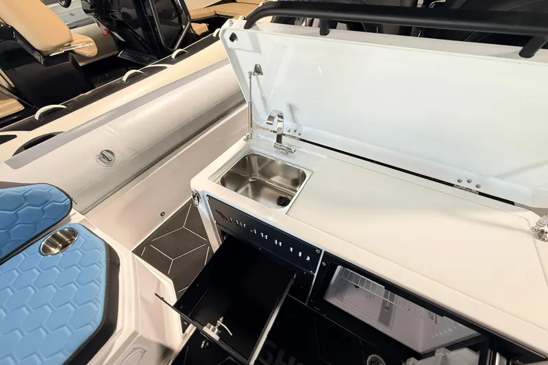 Slide: The Image of 2026 Highfield ADV7 boat interior with sink, storage, and seating. - 13