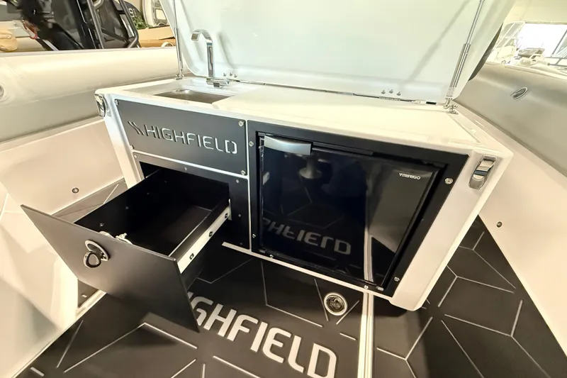 Slide: The Image of Highfield ADV7 2026 boat interior with sink, storage drawer, and mini fridge. - 14