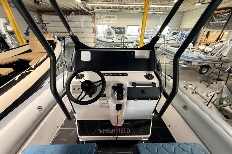 Slide: The Image of 2026 Highfield ADV7 boat dashboard in showroom with steering wheel and controls. - 15