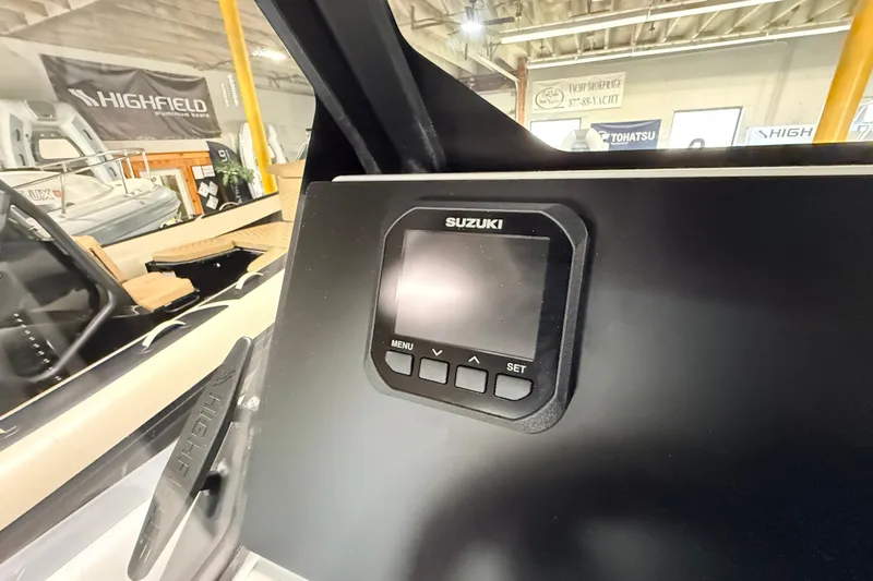 Slide: The Image of Suzuki display on 2026 Highfield ADV7 boat dashboard in showroom setting. - 16