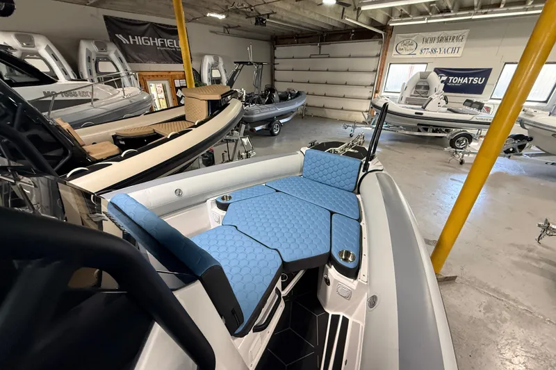 Slide: The Image of 2026 Highfield ADV7 boat with blue seating in a showroom. - 17