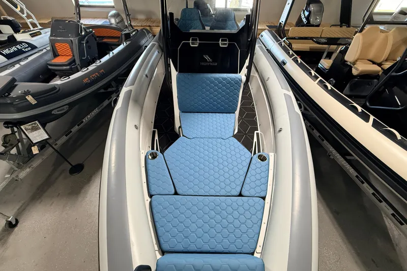 Slide: The Image of 2026 Highfield ADV7 boat interior with blue cushioned seating and sleek design. - 19