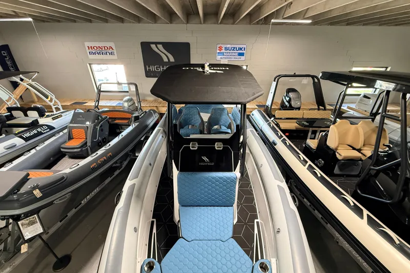 Slide: The Image of 2026 Highfield ADV7 boats displayed in a showroom with various models and seating arrangements. - 20