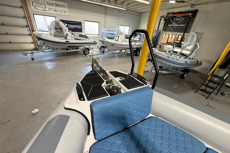 Slide: The Image of 2026 Highfield ADV7 boats displayed in a showroom with blue seating and modern design. - 22