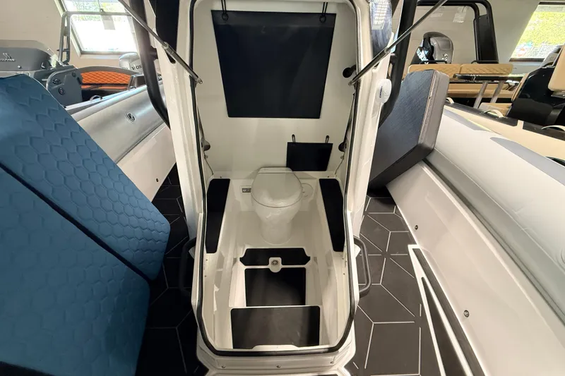 Slide: The Image of Interior of 2026 Highfield ADV7 boat featuring a compact marine toilet setup. - 23