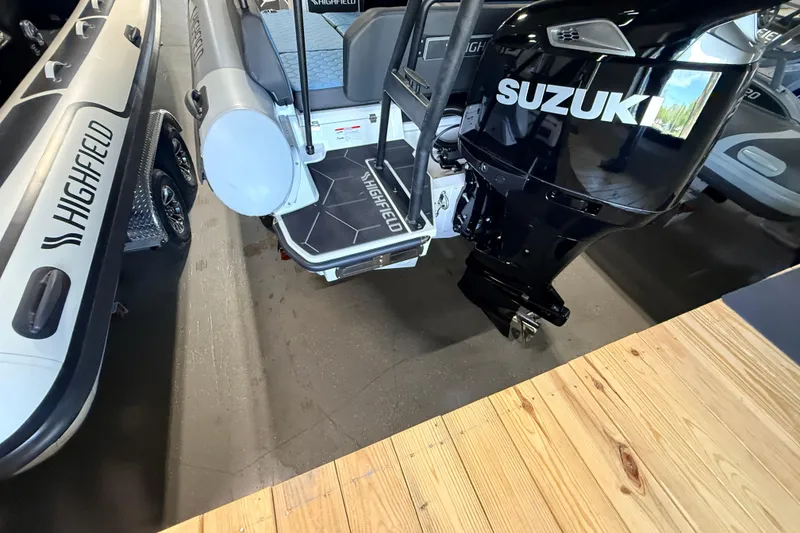 Slide: The Image of 2026 Highfield ADV7 boat with Suzuki outboard motor in showroom. - 29
