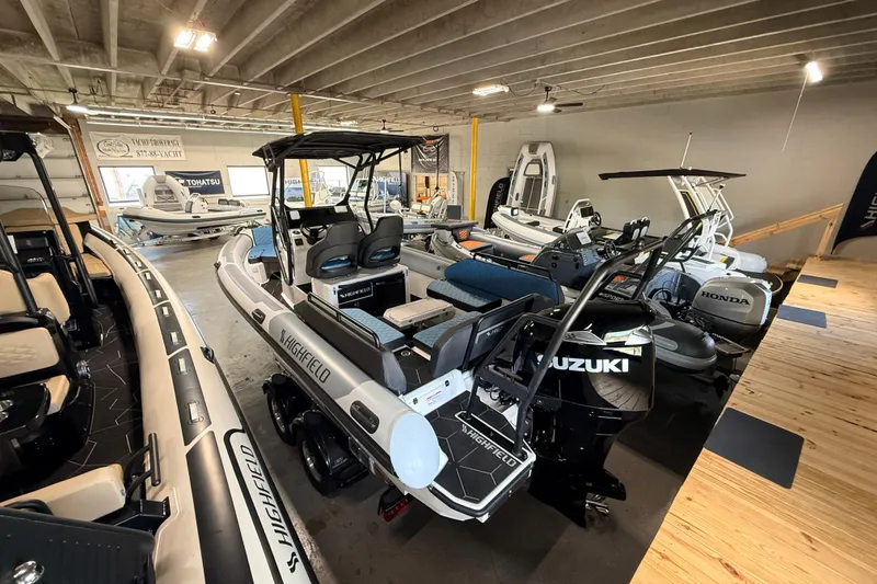 Slide: The Image of 2026 Highfield ADV7 boat with Suzuki engine in showroom, surrounded by other boats. - 3