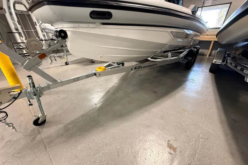 Slide: The Image of 2026 Highfield ADV7 boat on EZ Loader trailer in indoor storage. - 30