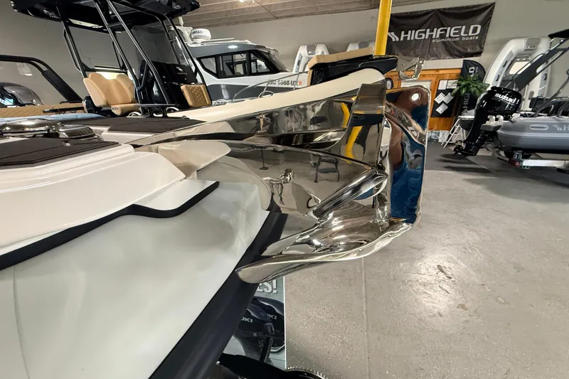 Slide: The Image of 2026 Highfield ADV7 boat with sleek chrome detailing in a showroom. - 33