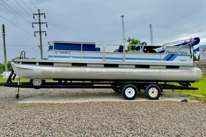 The Image of 1989 Godfrey Aqua Patio 2424 pontoon boat on trailer, parked on gravel. - 1