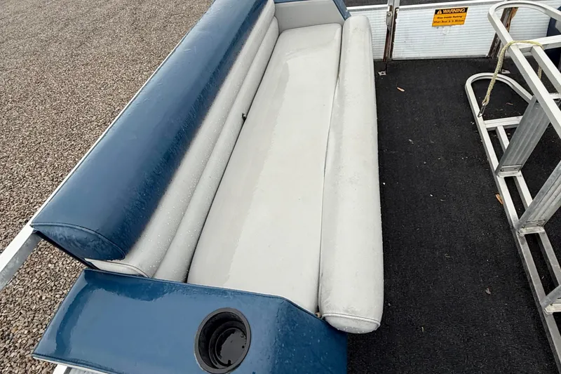 Slide: The Image of Blue and white seating on 1989 Godfrey Aqua Patio 2424 boat deck. - 10