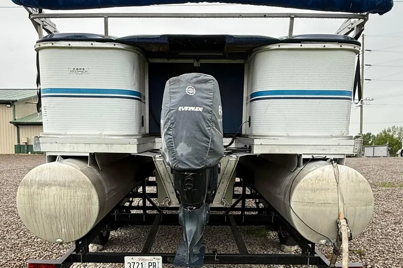 Slide: The Image of 1989 Godfrey Aqua Patio 2424 pontoon boat with Evinrude motor, parked on gravel. - 4