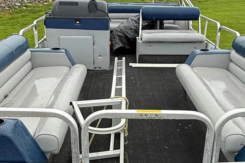 Slide: The Image of Interior of a 1989 Godfrey Aqua Patio 2424 pontoon boat with seating and railing. - 5