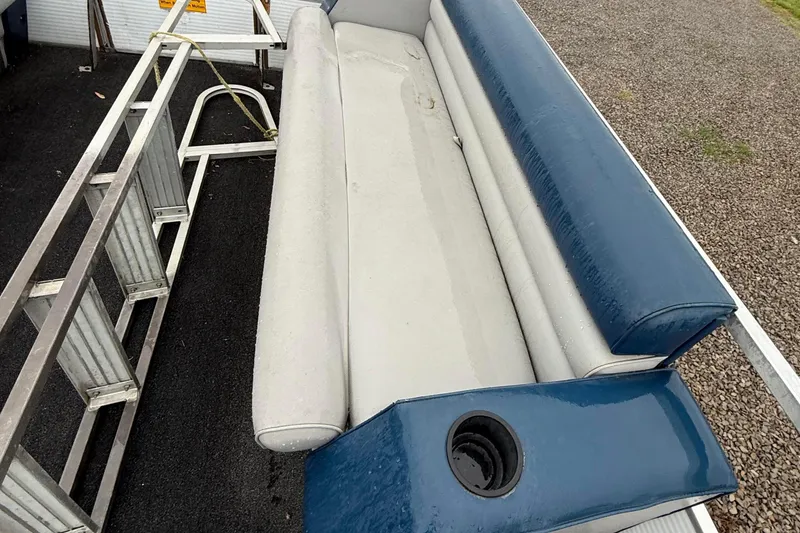 Slide: The Image of 1989 Godfrey Aqua Patio 2424 boat seat with blue and white upholstery, cup holder, and metal railing. - 9