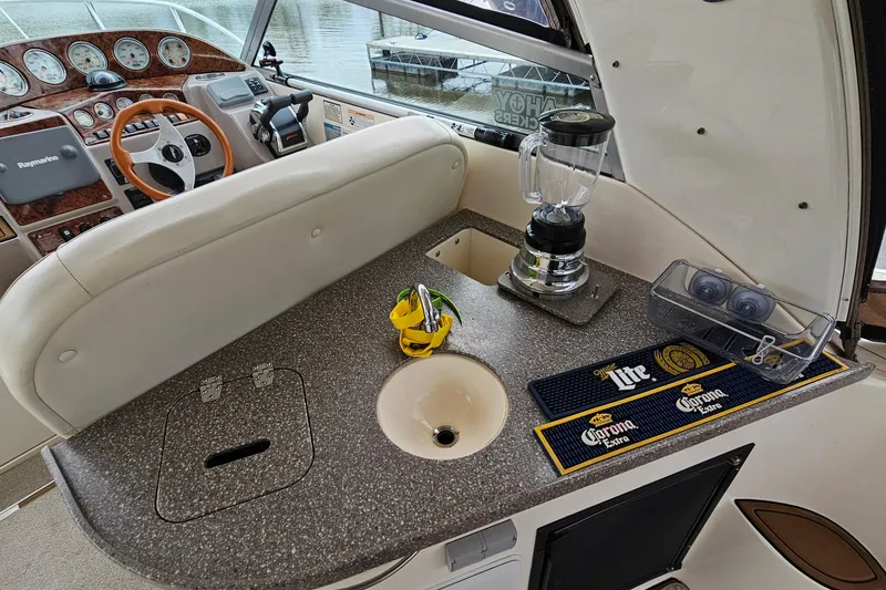 Slide: The Image of 2004 Rinker Fiesta Vee 312 boat interior with helm, blender, and countertop accessories. - 10