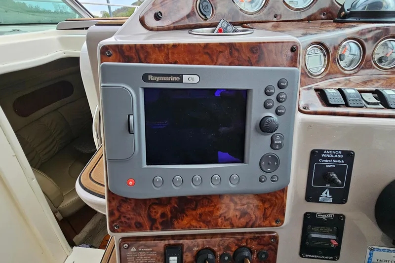Slide: The Image of 2004 Rinker Fiesta Vee 312 dashboard with Raymarine C70 navigation system. - 13