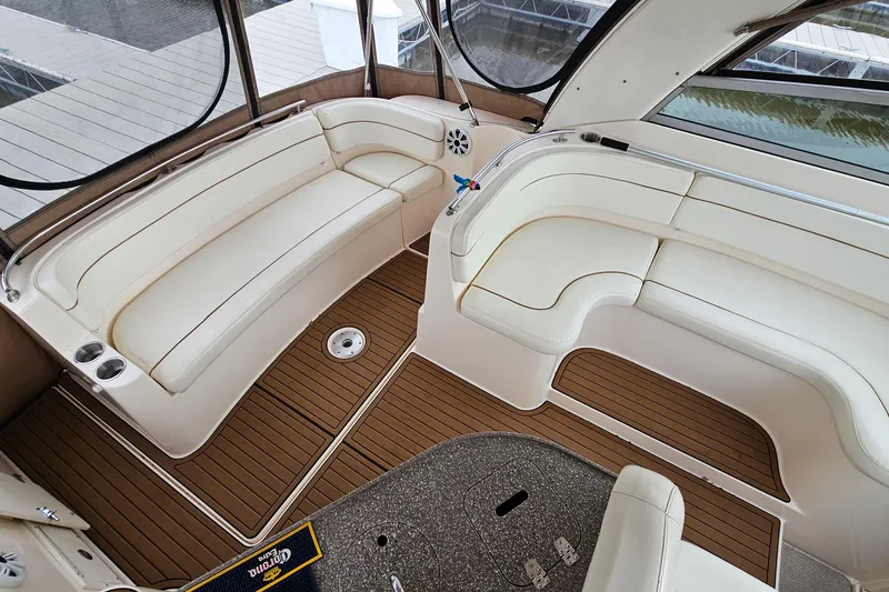 Slide: The Image of 2004 Rinker Fiesta Vee 312 boat interior with cream seating and wood flooring. - 18