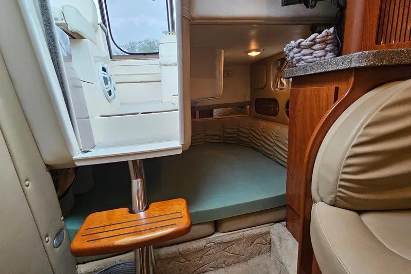 Slide: The Image of Interior of 2004 Rinker Fiesta Vee 312 boat, featuring cozy cabin and seating area. - 24