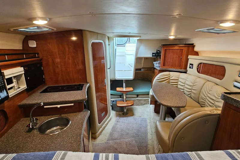 Slide: The Image of Interior of 2004 Rinker Fiesta Vee 312 boat with kitchenette and seating area. - 27