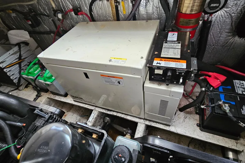 Slide: The Image of Engine room of 2004 Rinker Fiesta Vee 312 with Kohler generator and batteries. - 29
