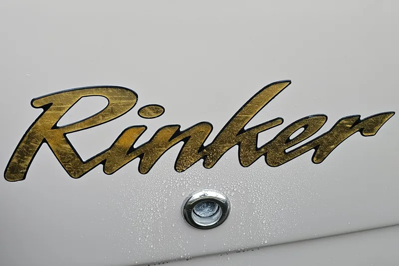 Slide: The Image of Rinker Fiesta Vee 312 logo on 2004 boat with water droplets. - 33