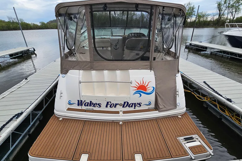 Slide: The Image of 2004 Rinker Fiesta Vee 312 boat docked, featuring "Wakes For Days" graphic. - 5