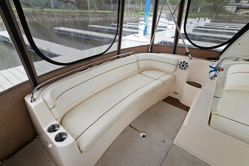 Slide: The Image of 2004 Rinker Fiesta Vee 312 boat interior with white seating and cup holders. - 8