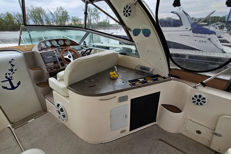 Slide: The Image of 2004 Rinker Fiesta Vee 312 boat interior with helm, seating, and dashboard controls. - 9